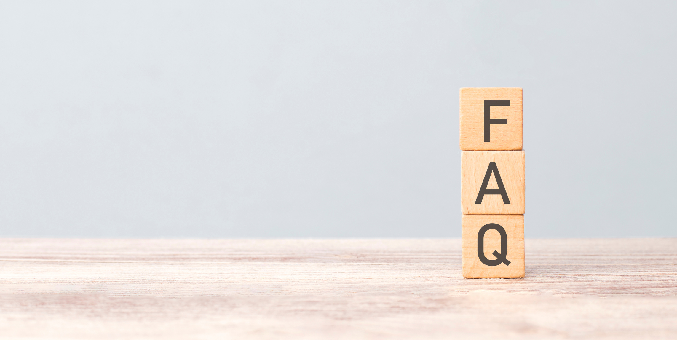 frequently asked questions concept. writes faq on wooden cubes